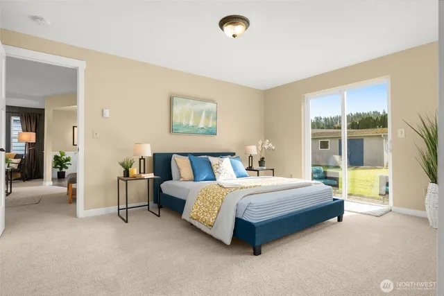 a spacious bedroom with a bed and a large window