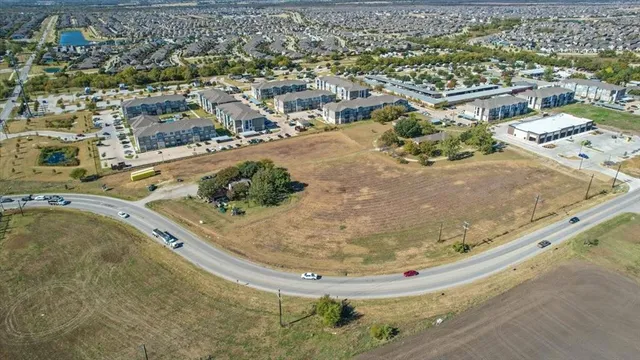 an aerial view of a house with a yard and lake