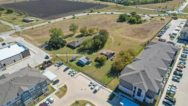 an aerial view of a house with a yard