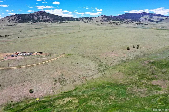 a view of a big yard with lots of green space