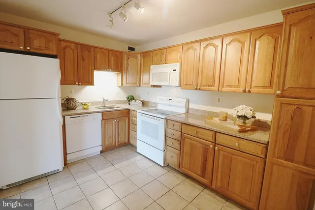 a kitchen with granite countertop cabinets stainless steel appliances and a sink