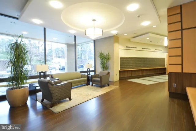 a living room with fireplace furniture and a large window