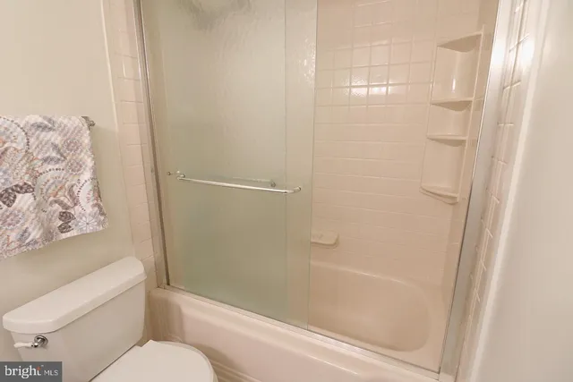 a bathroom with a toilet and shower