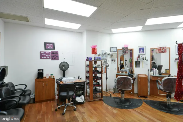 a work room with furniture and wooden floor