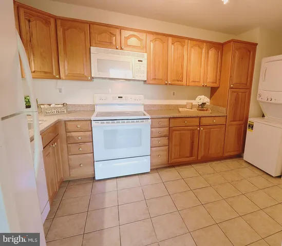 a kitchen with a stove sink and cabinets