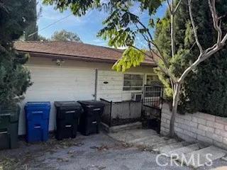 a view of a house with a yard and furniture