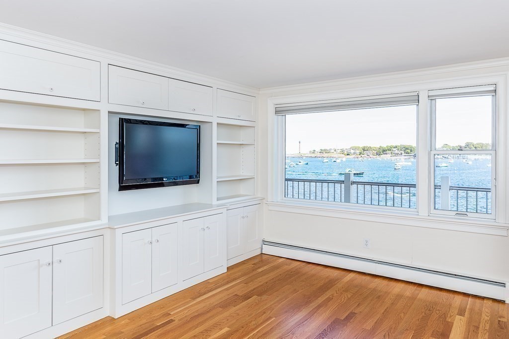 147 Front Street, Unit 6 Marblehead, MA 01945 - Photo 12 of 25 a view of an empty room with a window and wooden floor