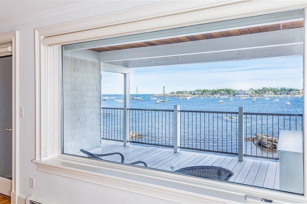 147 Front Street, Unit 6 Marblehead, MA 01945 - Photo 2 of 25 a view of a balcony with wooden floor and fence