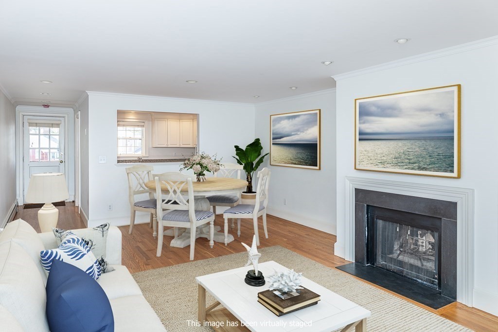 147 Front Street, Unit 6 Marblehead, MA 01945 - Photo 7 of 25 a living room with furniture a rug and a fireplace