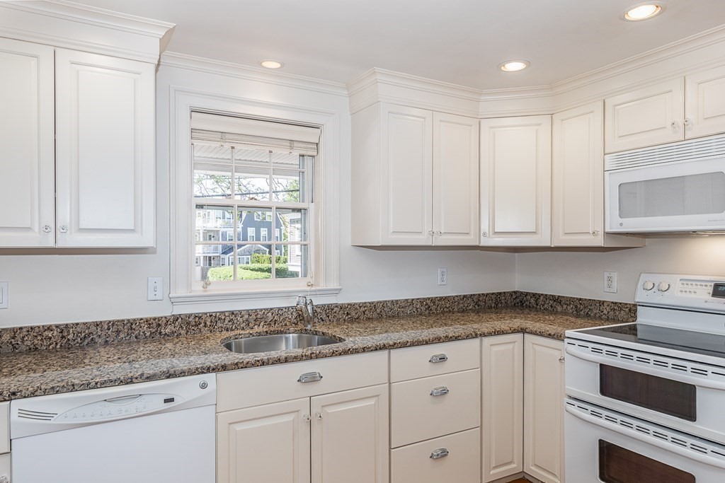 147 Front Street, Unit 6 Marblehead, MA 01945 - Photo 9 of 25 a kitchen with granite countertop white cabinets and a sink