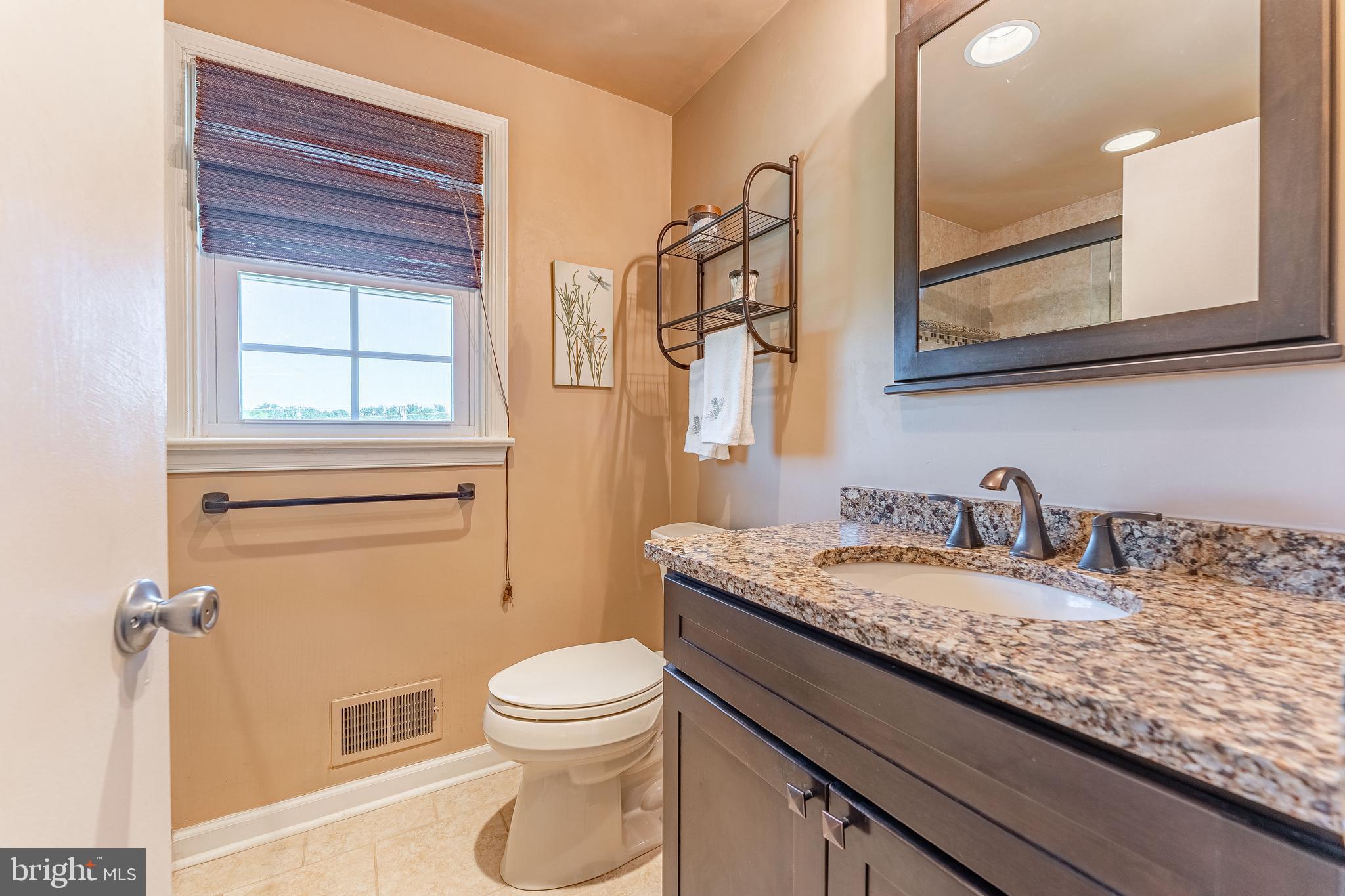 84 North Spring Lane Phoenixville, PA 19460 - Photo 42 of 51 a bathroom with a granite countertop toilet sink and mirror