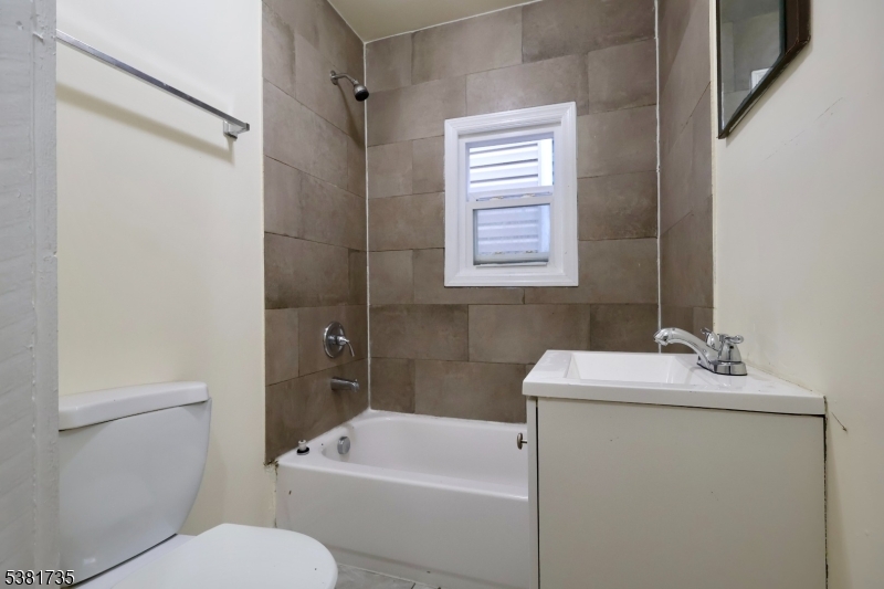 112 Chadwick Avenue, Unit 2 Newark, NJ 07108 - Photo 11 of 13 a bathroom with a sink a toilet and shower