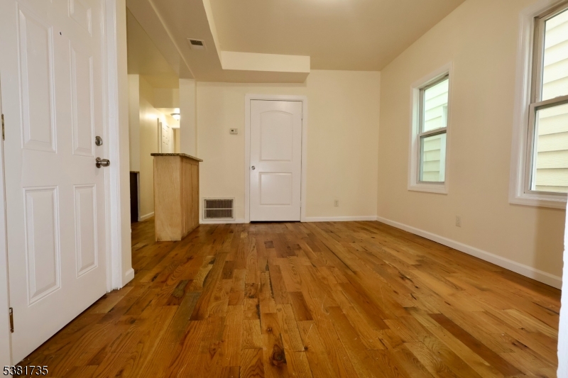 112 Chadwick Avenue, Unit 2 Newark, NJ 07108 - Photo 5 of 13 wooden floor in an empty room