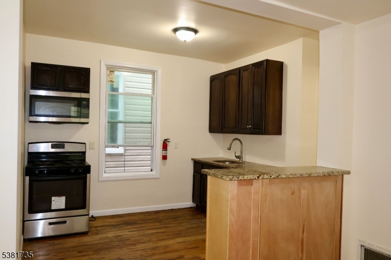 112 Chadwick Avenue, Unit 2 Newark, NJ 07108 - Photo 7 of 13 a bathroom with a sink and a mirror
