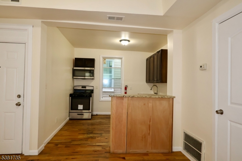 112 Chadwick Avenue, Unit 2 Newark, NJ 07108 - Photo 8 of 13 a view of a kitchen with furniture and wooden floor