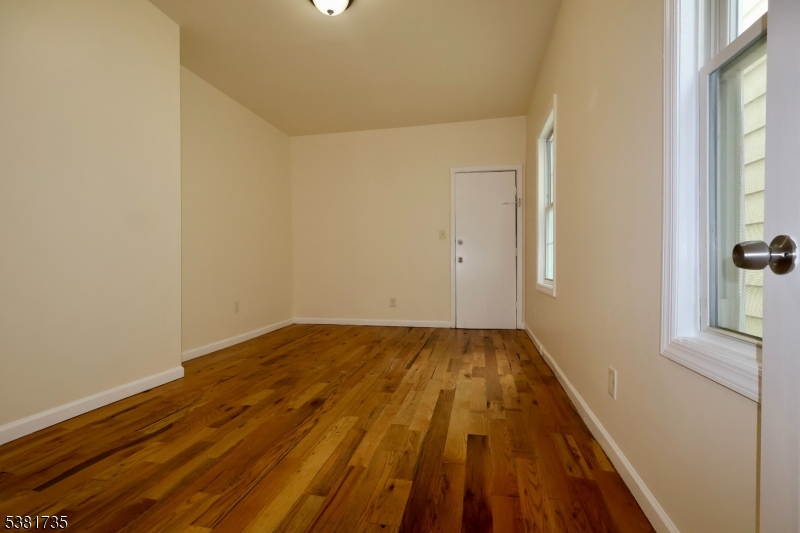 112 Chadwick Avenue, Unit 2 Newark, NJ 07108 - Photo 9 of 13 a view of an empty room and wooden floor