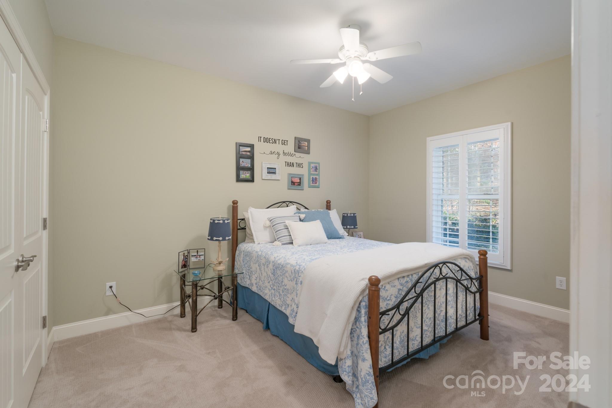 638 Deerfield Road Mount Gilead, NC 27306 - Photo 16 of 48 a bedroom with a bed a window and a chandelier