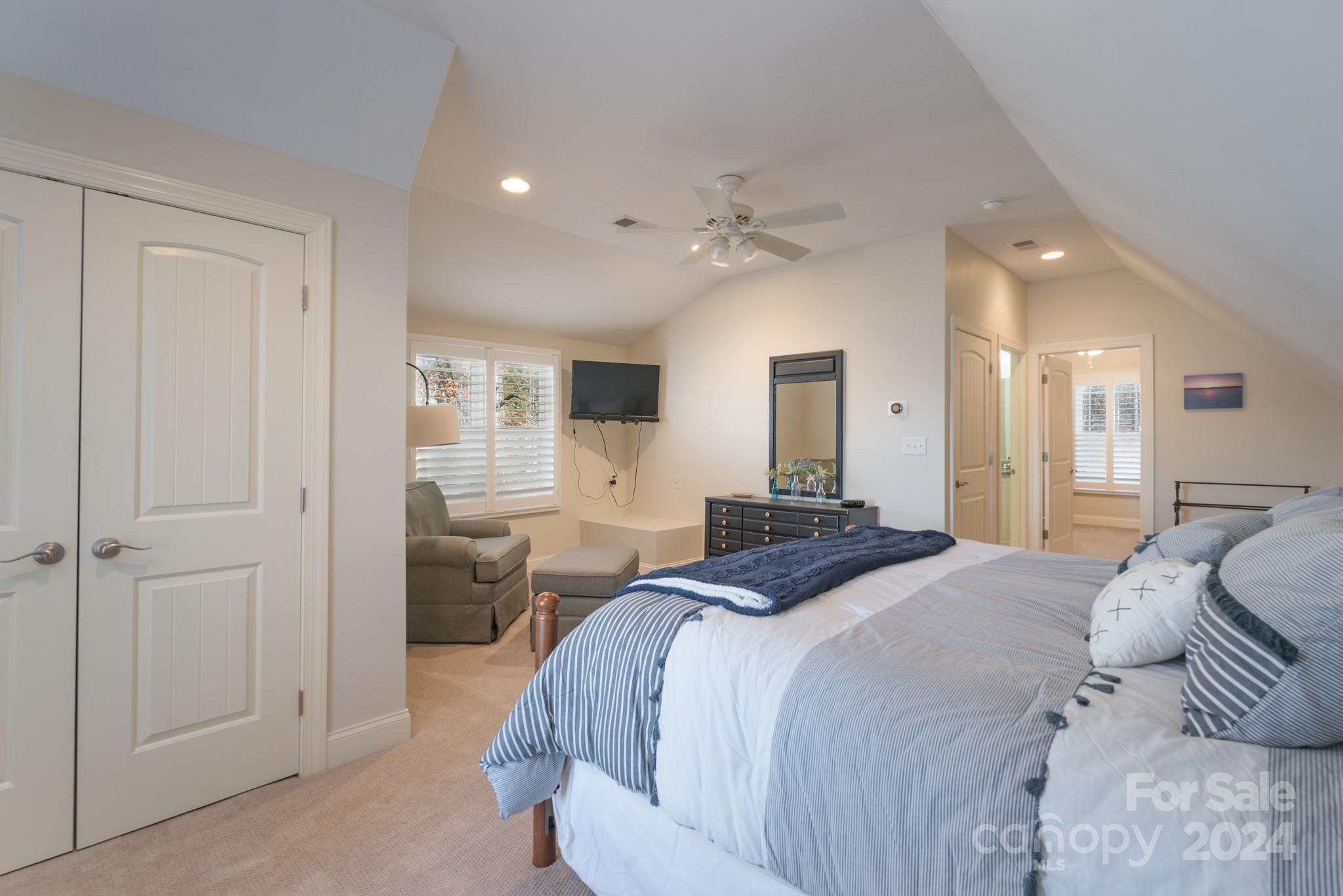 638 Deerfield Road Mount Gilead, NC 27306 - Photo 18 of 48 a spacious bedroom with a bed and a chandelier