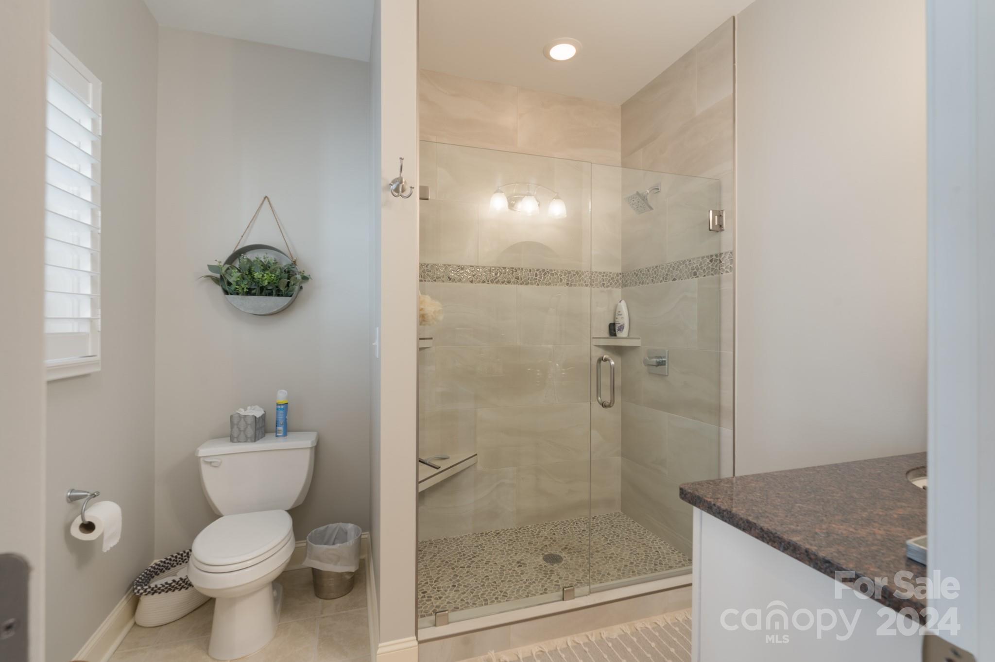 638 Deerfield Road Mount Gilead, NC 27306 - Photo 20 of 48 a bathroom with a granite countertop toilet and a sink