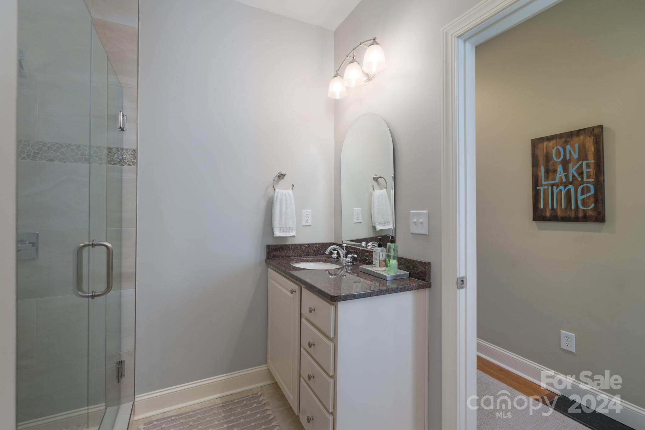 638 Deerfield Road Mount Gilead, NC 27306 - Photo 21 of 48 a bathroom with a sink vanity and shower