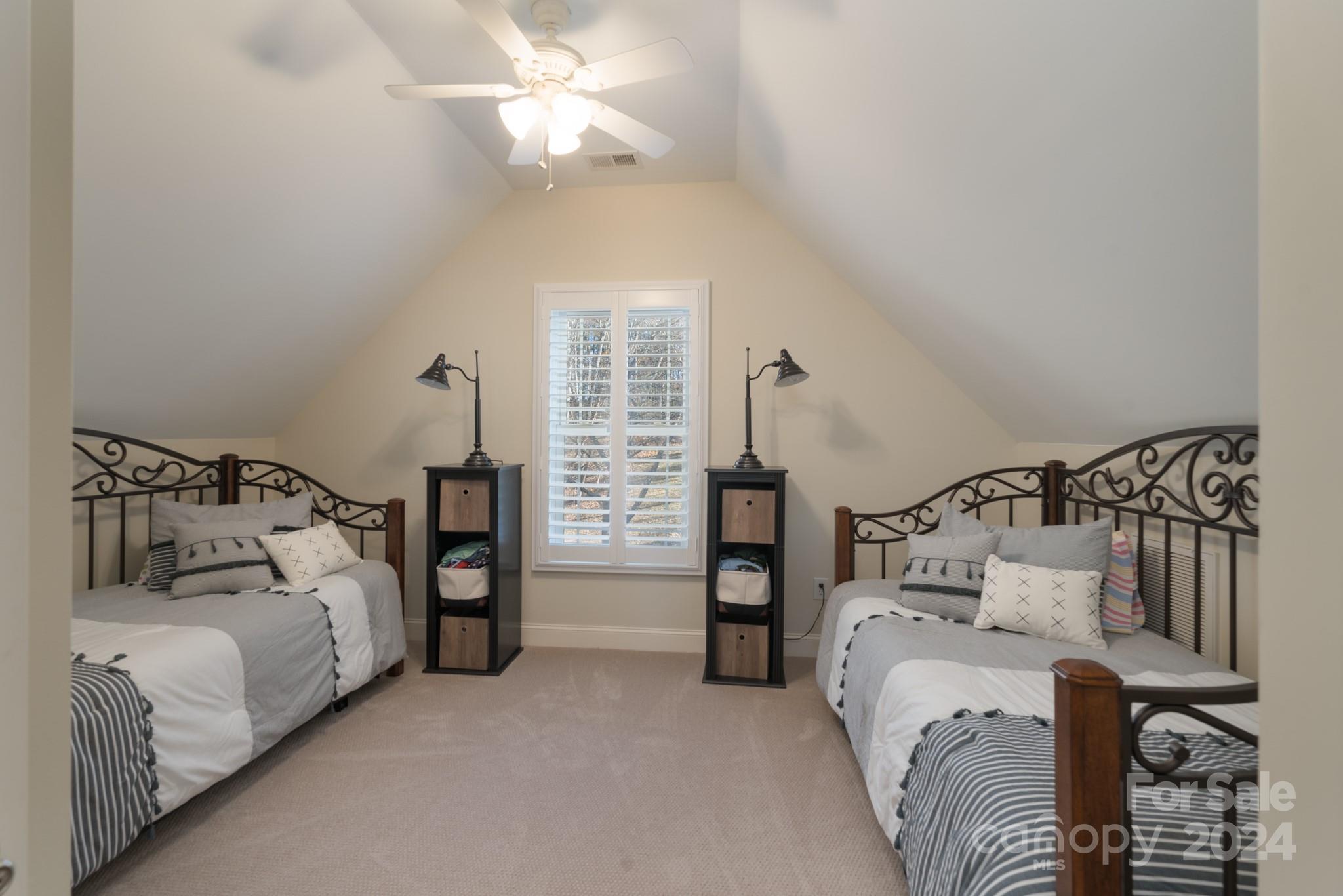 638 Deerfield Road Mount Gilead, NC 27306 - Photo 23 of 48 a bedroom with a bed and a chandelier