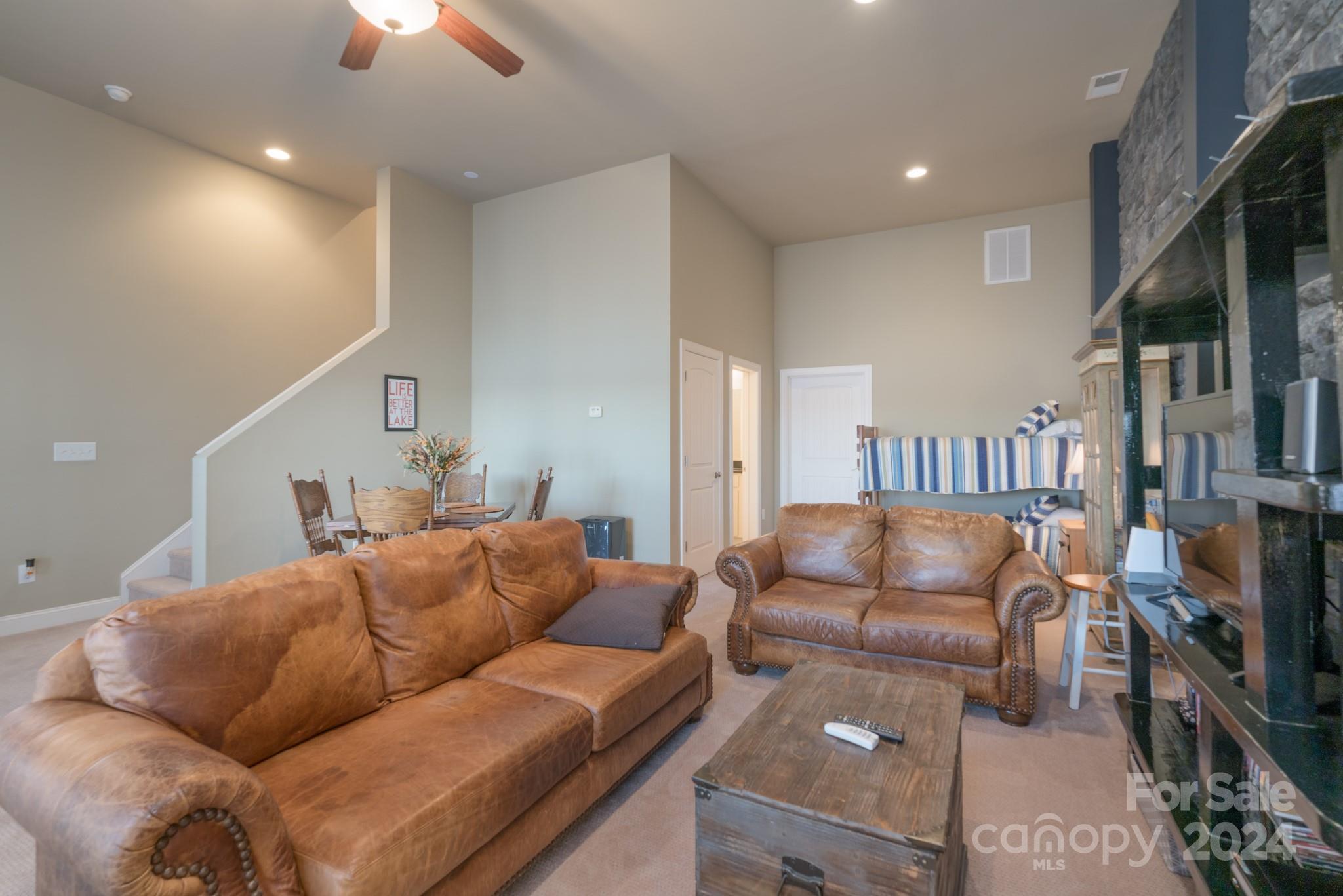 638 Deerfield Road Mount Gilead, NC 27306 - Photo 30 of 48 a living room with furniture a flat screen tv and a fireplace