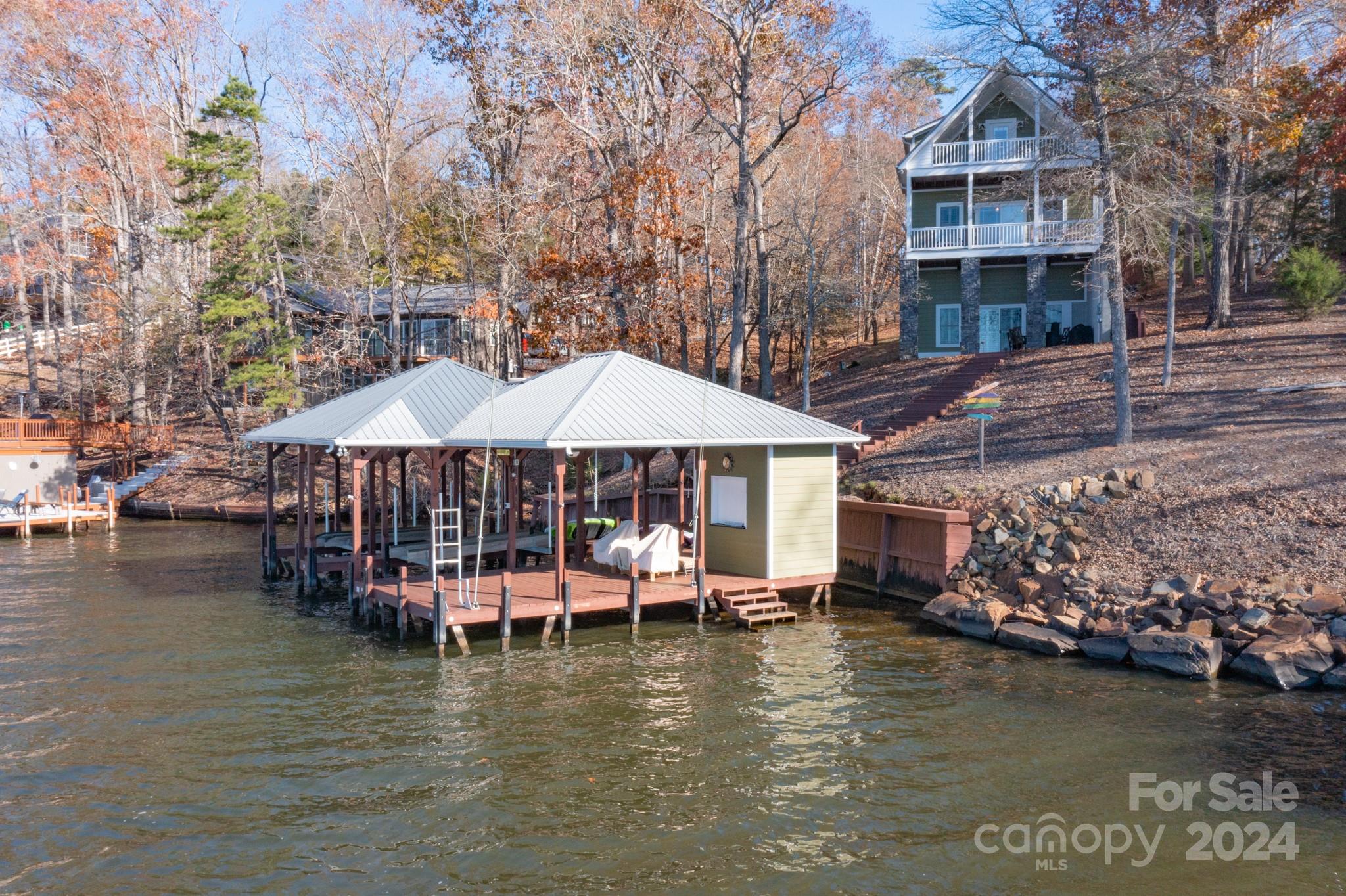 638 Deerfield Road Mount Gilead, NC 27306 - Photo 37 of 48 a small pool with lawn chairs under an umbrella