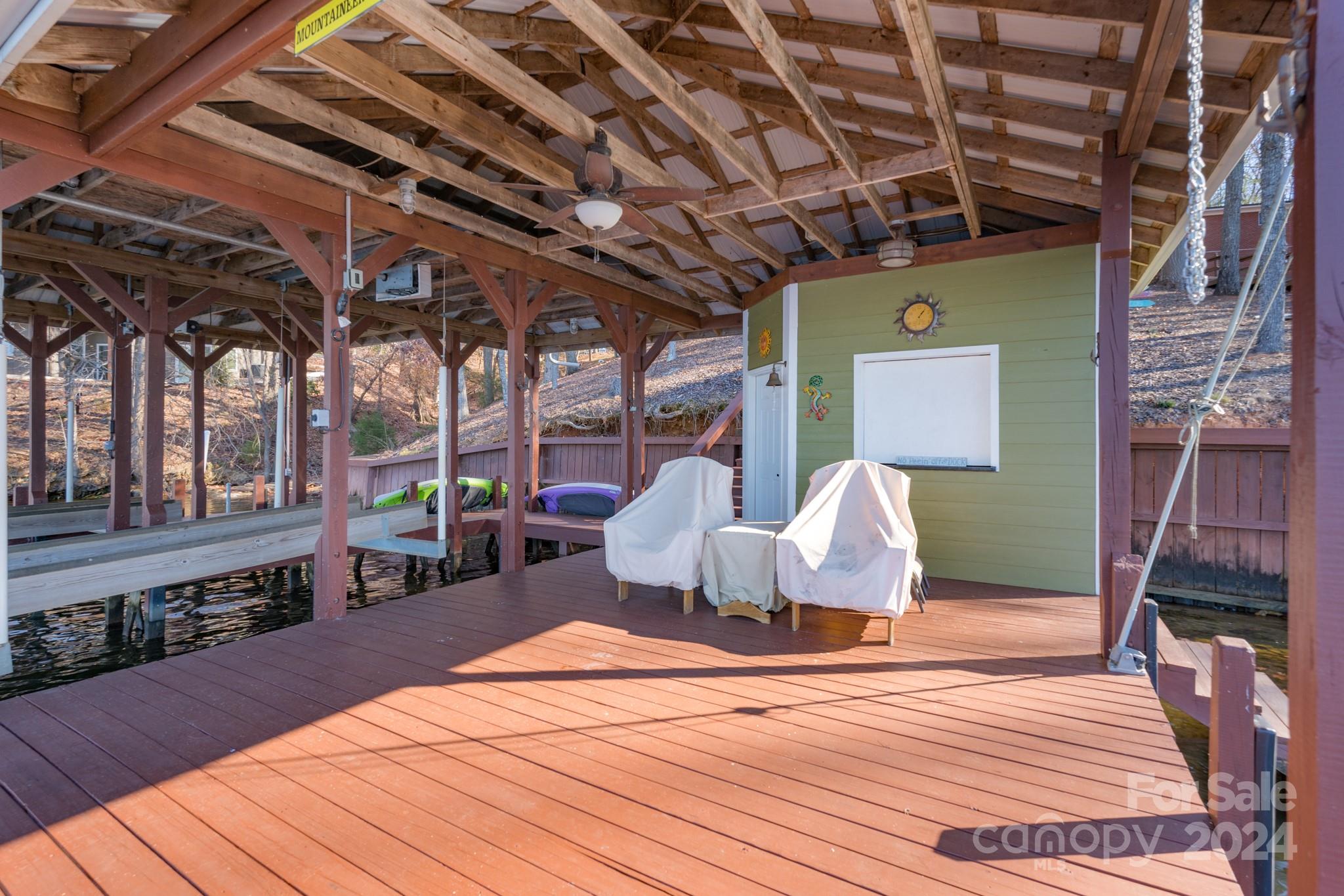 638 Deerfield Road Mount Gilead, NC 27306 - Photo 39 of 48 a view of a roof deck with chair and wooden floor