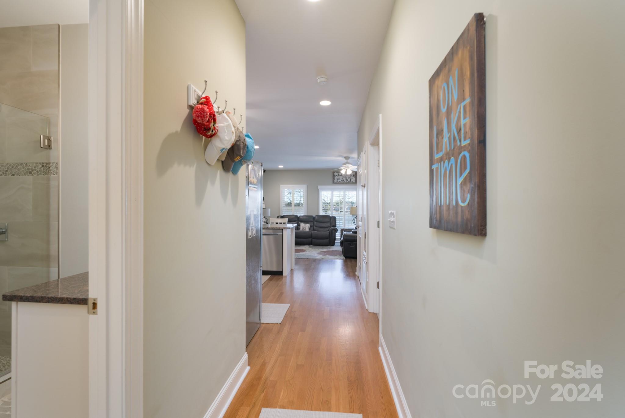638 Deerfield Road Mount Gilead, NC 27306 - Photo 6 of 48 a view of a hallway with wooden floor a cabinet and a living room