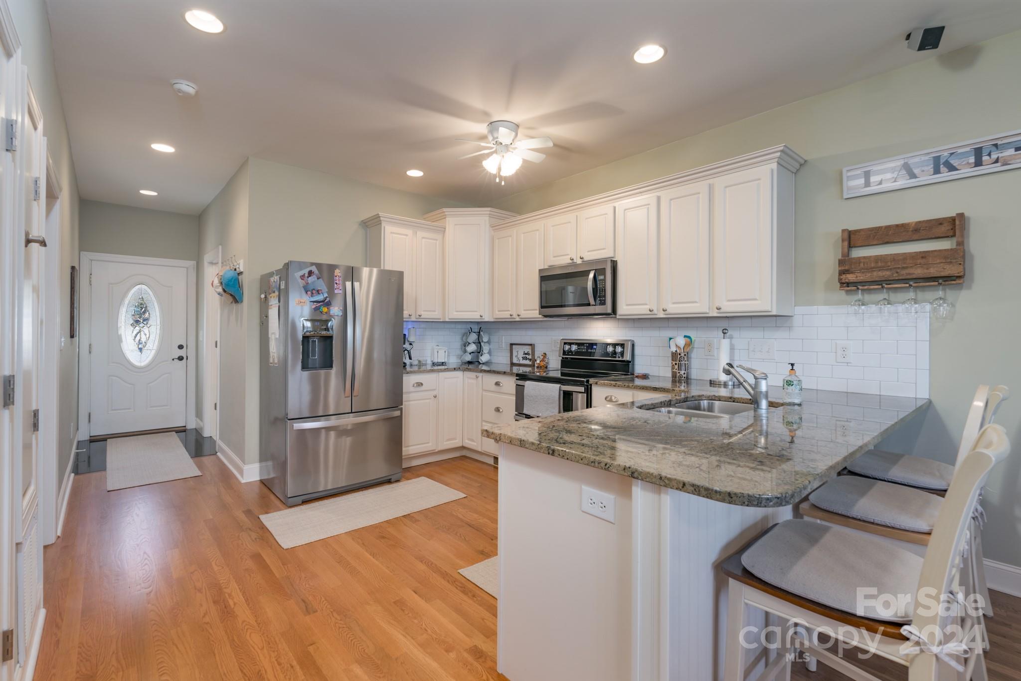 638 Deerfield Road Mount Gilead, NC 27306 - Photo 9 of 48 a kitchen with stainless steel appliances granite countertop a refrigerator a stove top oven a sink and dishwasher
