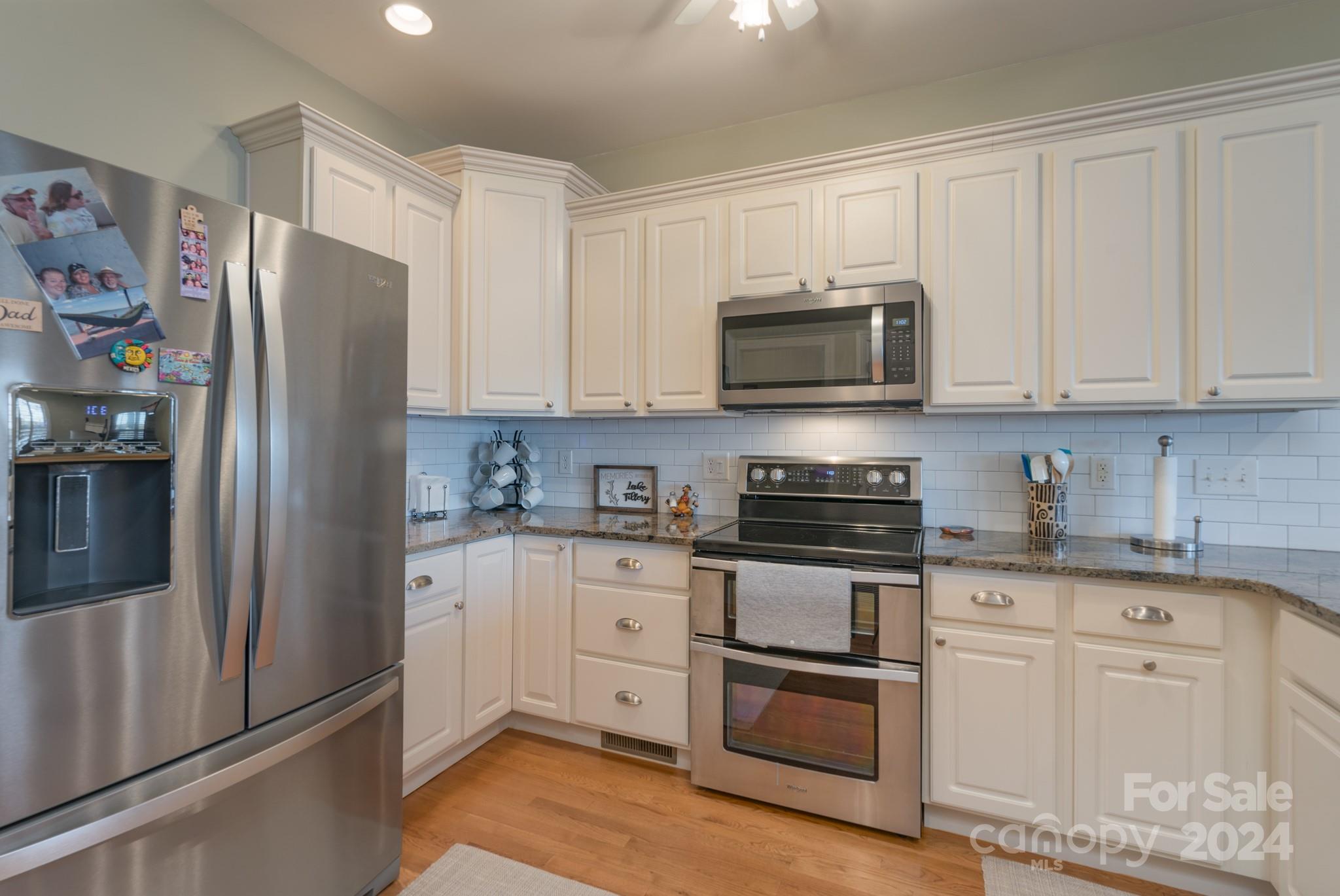 638 Deerfield Road Mount Gilead, NC 27306 - Photo 10 of 48 a kitchen with stainless steel appliances granite countertop a refrigerator stove and microwave
