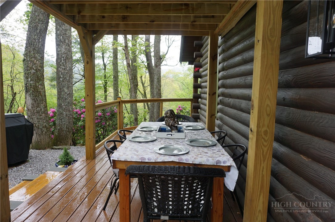 557 White Pine Road Newland, NC 28657 - Photo 36 of 41 a view of a patio with table and chairs potted plants with wooden floor
