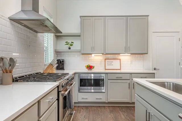 a kitchen with a sink stove top oven and cabinets