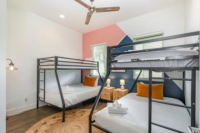 a bedroom with furniture and a mirror