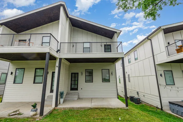 a view of a white house with a sink and front door