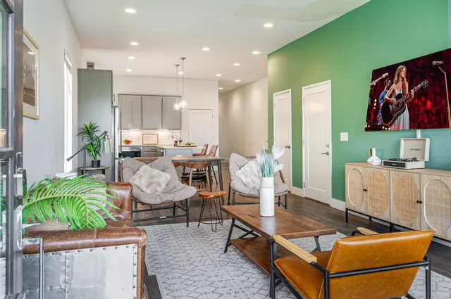a living room with furniture and wooden floor