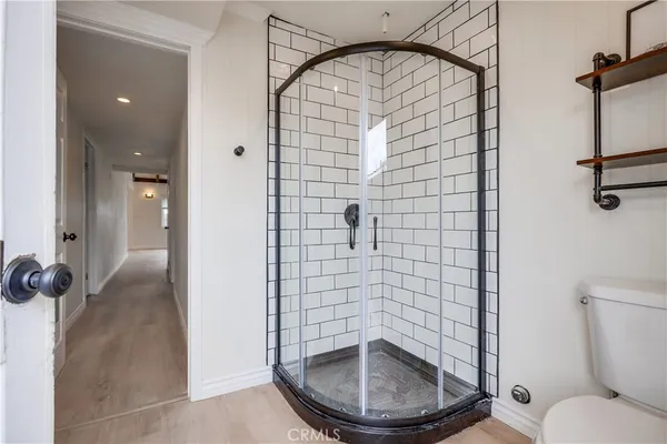 a bathroom with a toilet and a shower