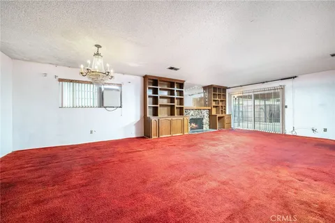 a big room with chandelier and windows