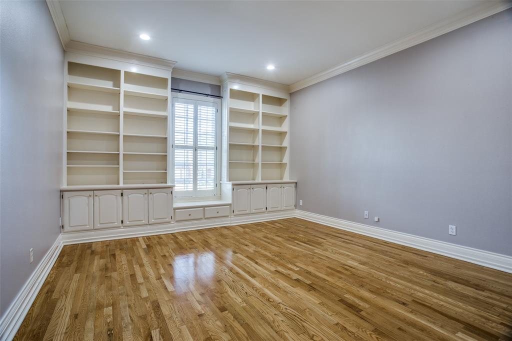 6509 Muirfield Road Fort Worth, TX 76132 - Photo 9 of 15 This bedroom is large and is split from the Primary Suite and the other two bedrooms. Offers built-in shelving, cabinets, and a walk-in closet. An ideal home office space.