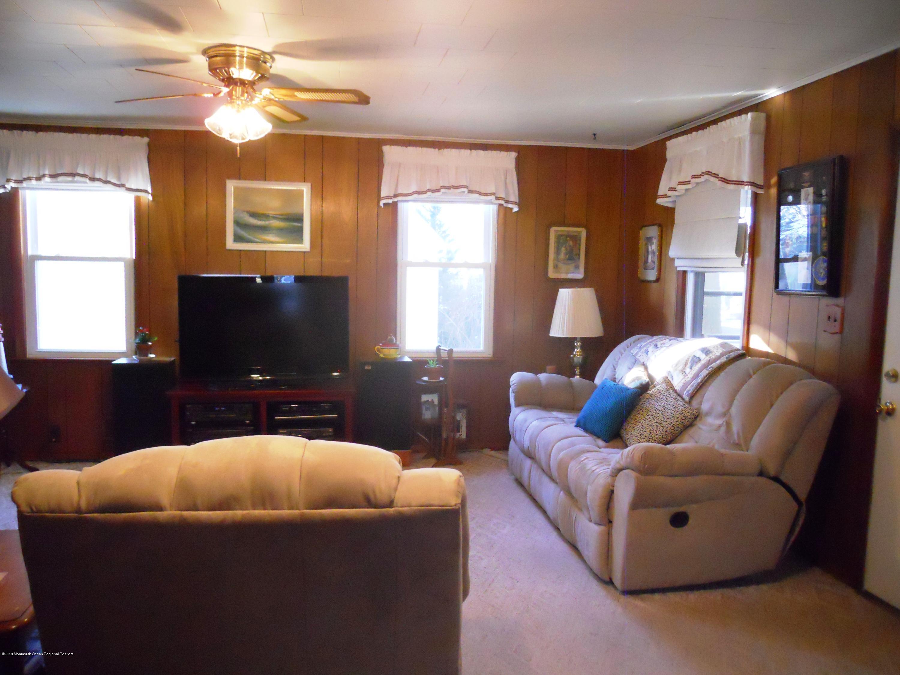 327 Cedar Road Point Pleasant, NJ 08742 - Photo 8 of 26 a living room with furniture and a flat screen tv
