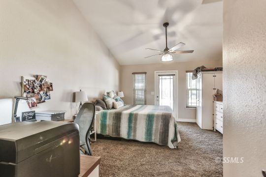 1220 Jennifer Court Ridgecrest, CA 93555 - Photo 21 of 34 a living room with furniture a chandelier and a dining table