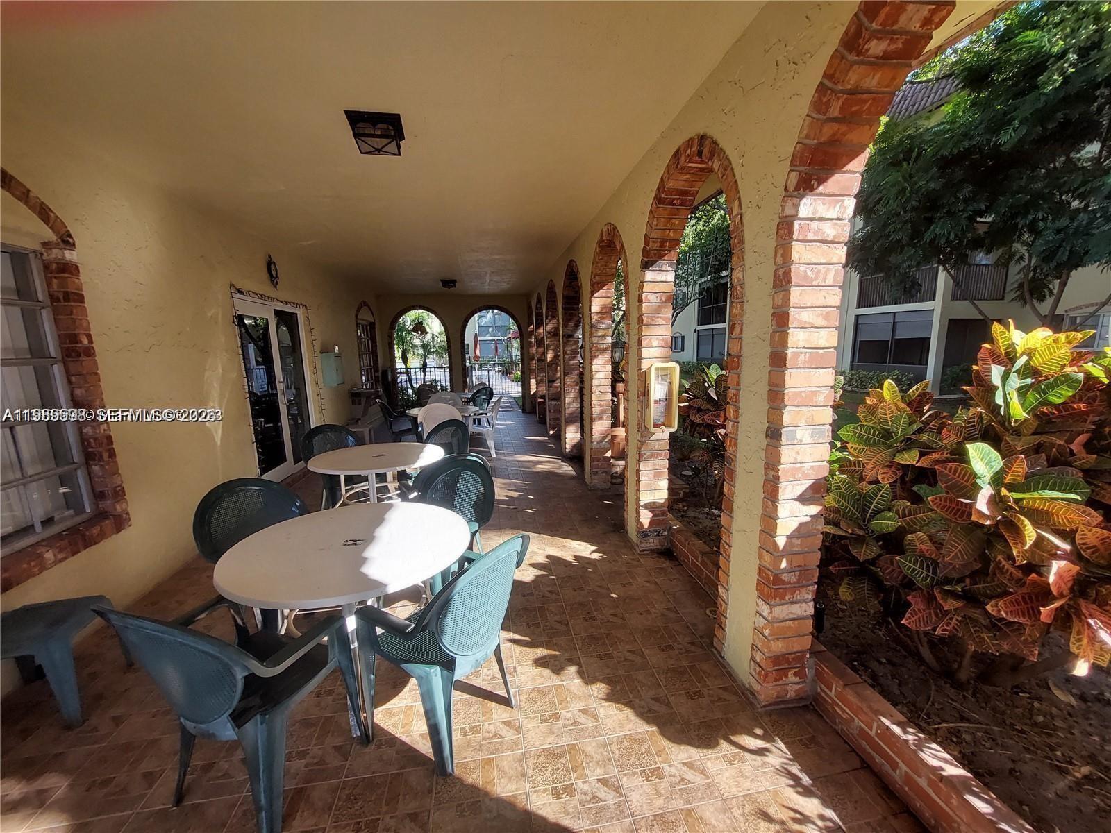 253 South Cypress Road, Unit 214 Pompano Beach, FL 33060 - Photo 24 of 25 a view of a dining room with furniture and a potted plant