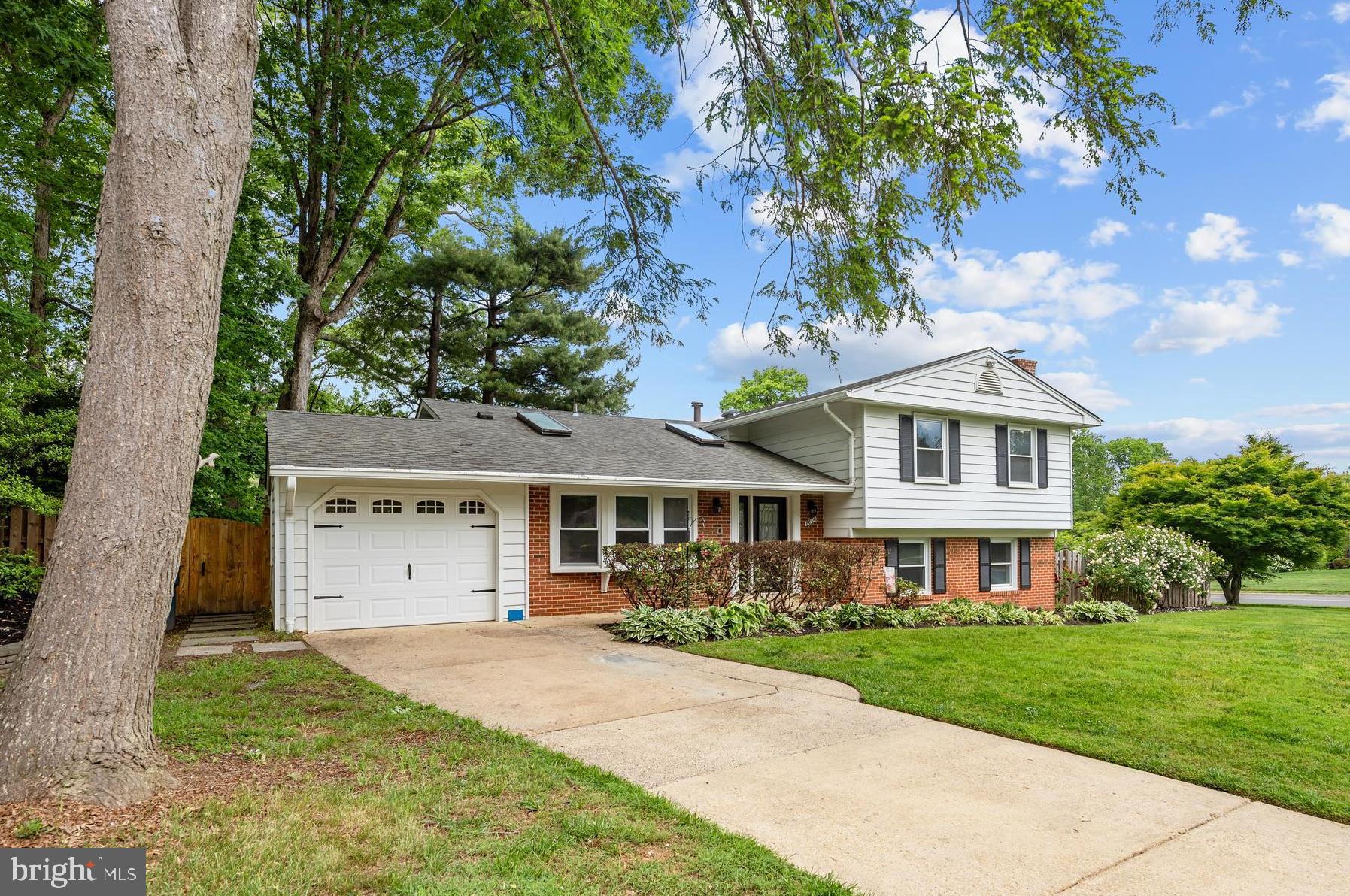 6800 Seton Court Springfield, VA 22152 - Photo 46 of 51 a front view of a house with a yard and garage