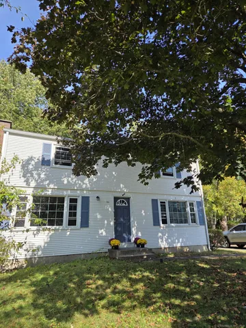 a front view of a house with a yard garage and outdoor seating