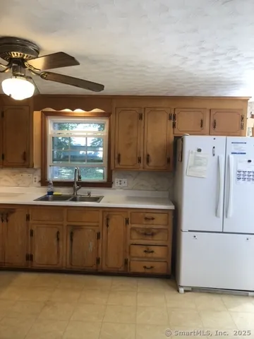 a kitchen with a refrigerator and a sink