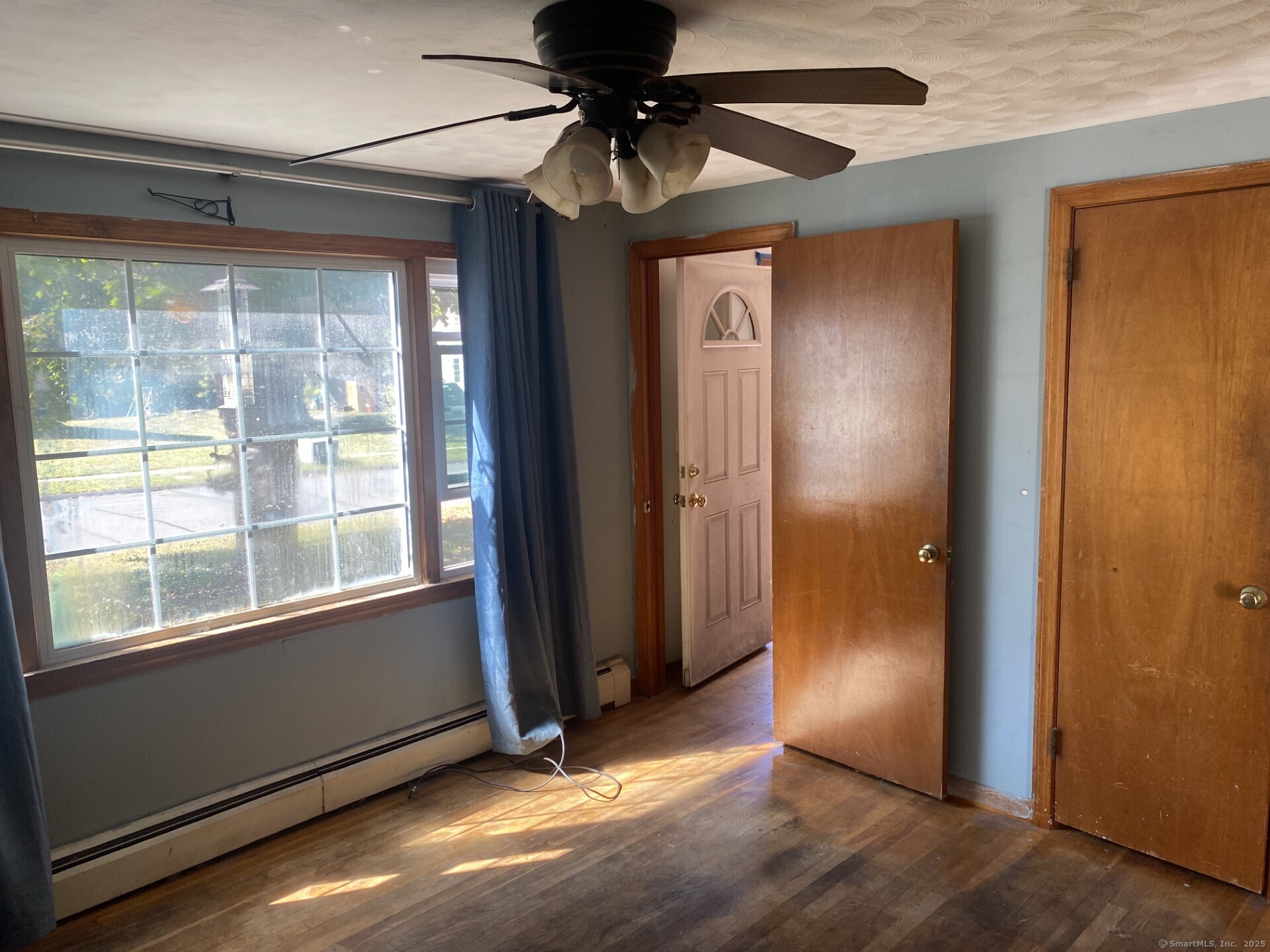 45 Monroe Road Enfield, CT 06082 - Photo 5 of 12 an empty room with a window and a chandelier fan