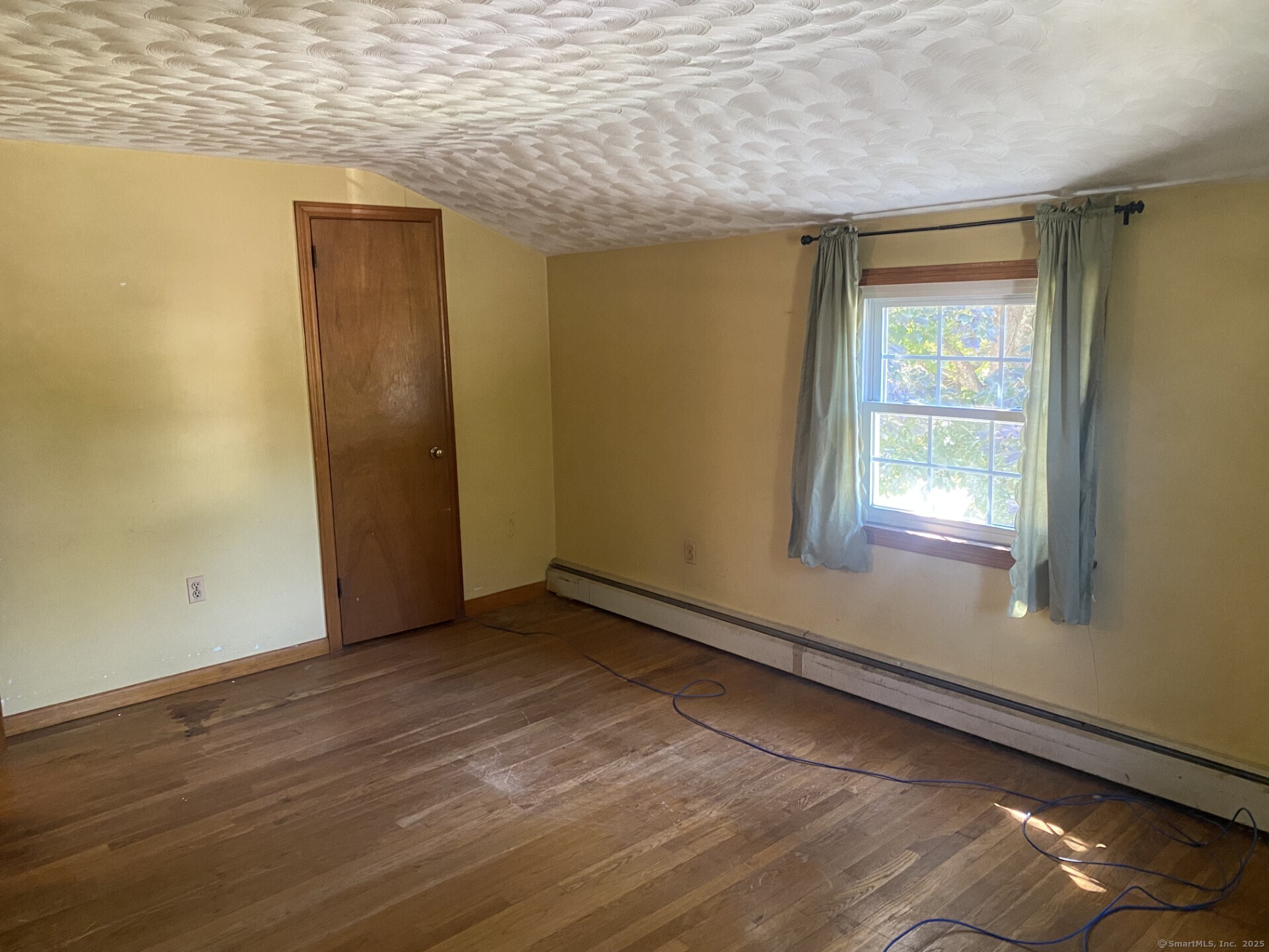 45 Monroe Road Enfield, CT 06082 - Photo 9 of 12 a view of an empty room with wooden floor and a window