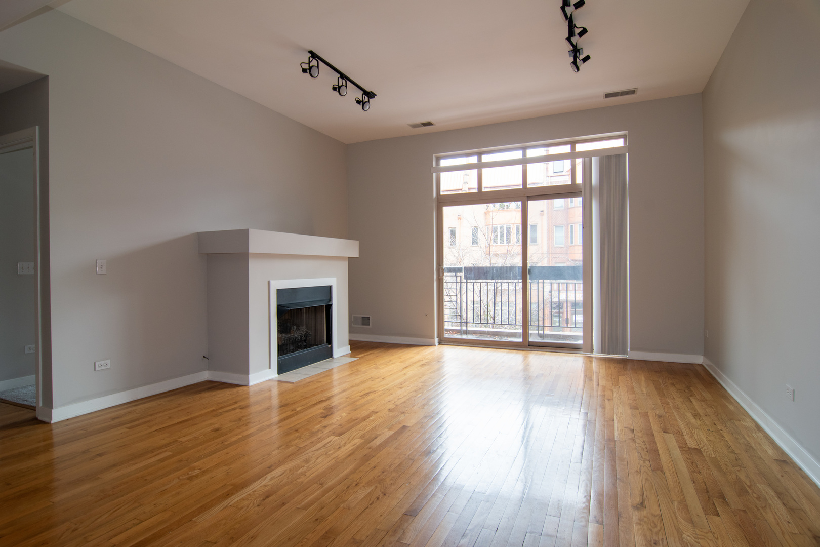 1900 South State Street, Unit 203 Chicago, IL 60616 - Photo 6 of 9 wooden floor fireplace and natural light in room