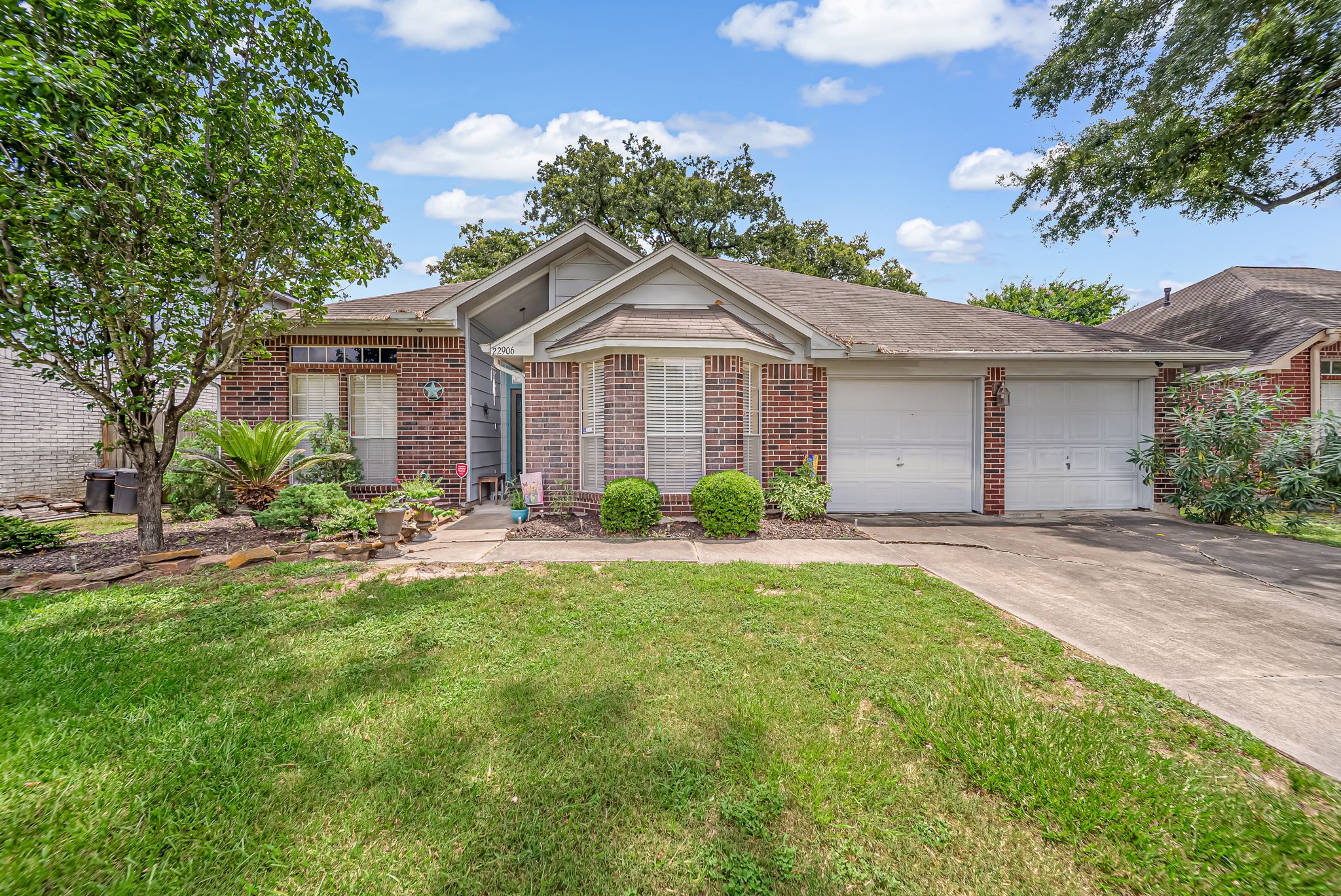 22906 Prairie Bird Lane Spring, TX 77373 - Photo 1 of 14 a front view of a house with yard and green space