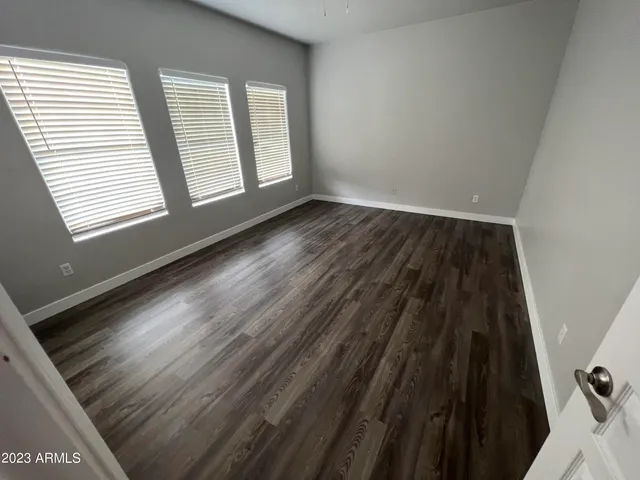 a view of wooden floor and windows in a room
